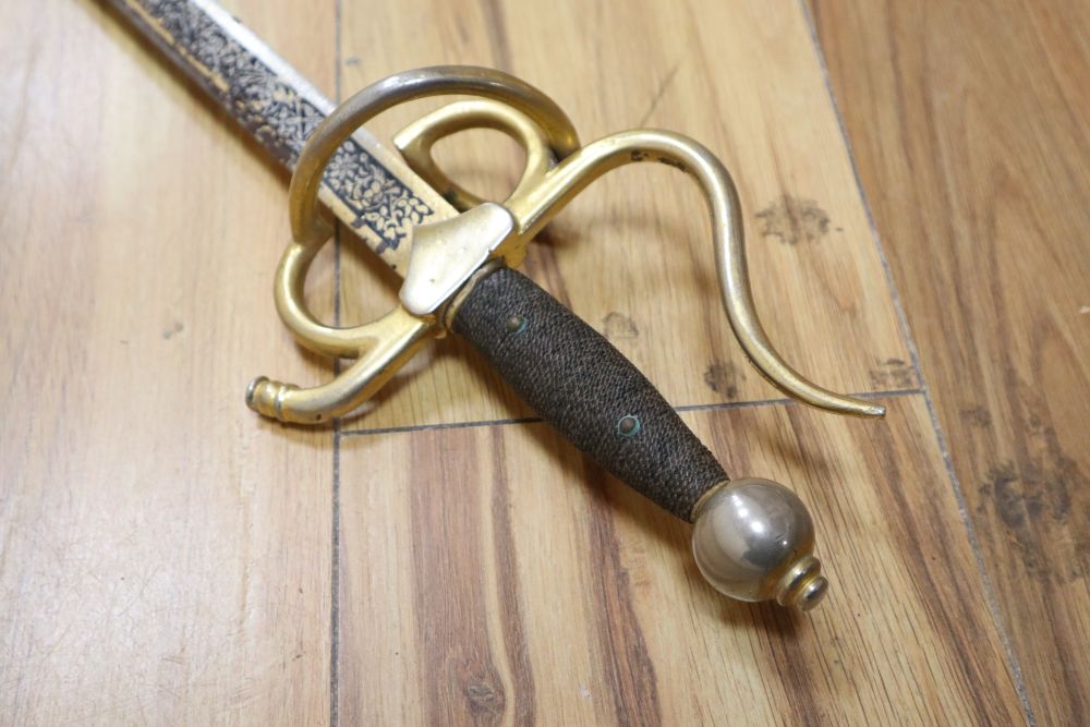 An officers sword with cast hilt and etched, 61cm double-edged blade